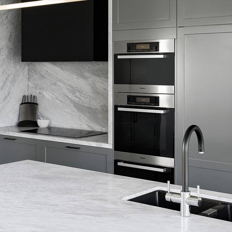 Marble counter top with black and gray cabinets
